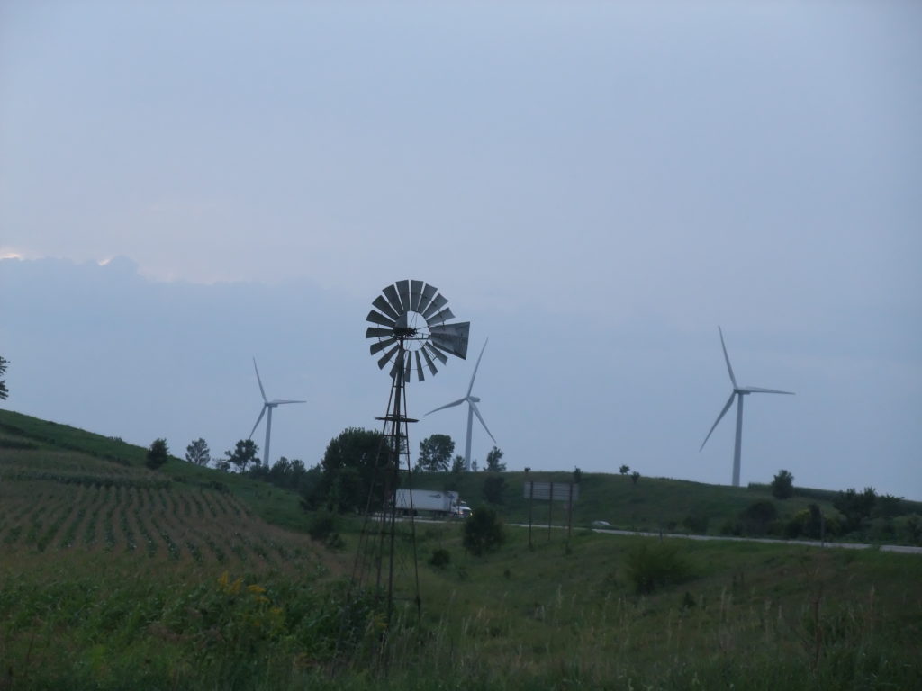 A Nebraska corn field with a windmill and wind turbines